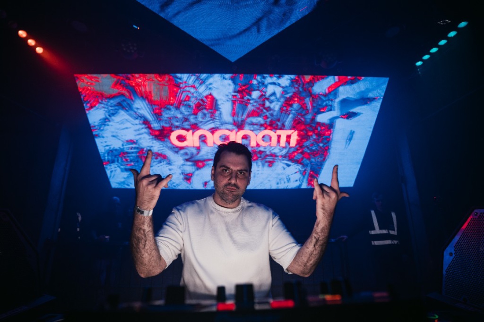 DJ and cheering crowd behind barricade — London Persian party event